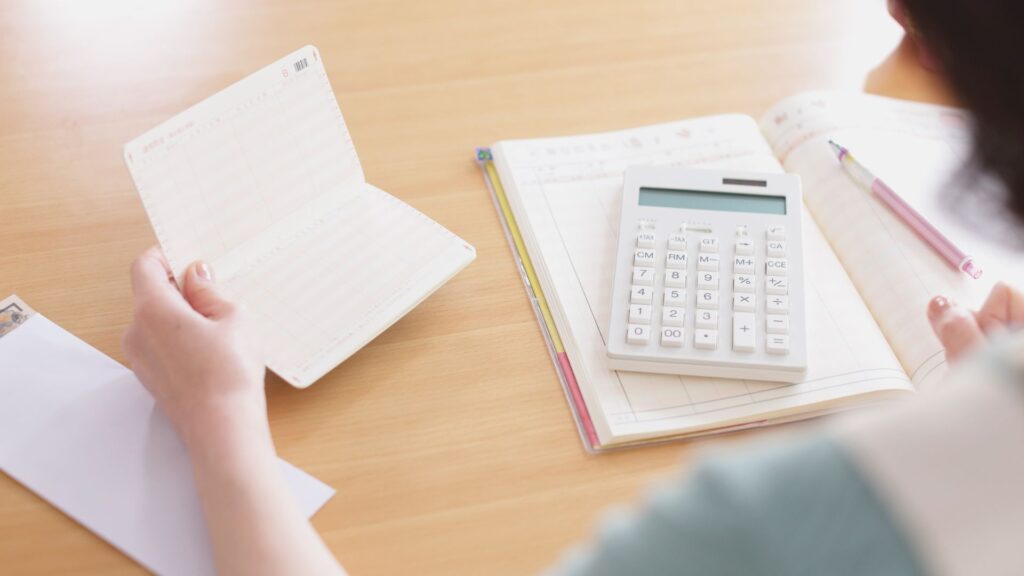 Budget planning with calculator, notebook, and pen on desk