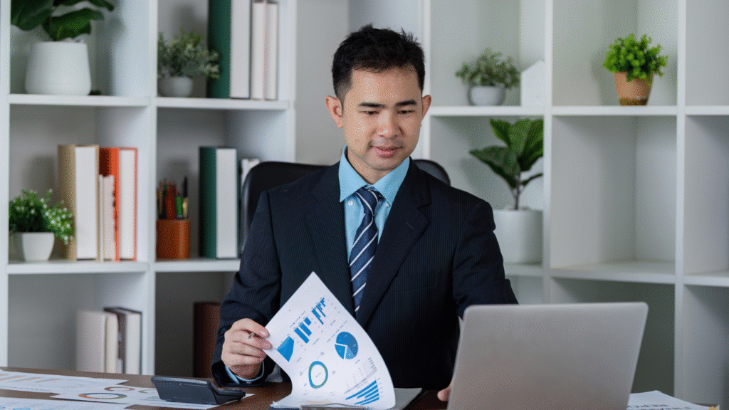 Business professional analyzing wealth management reports and graphs