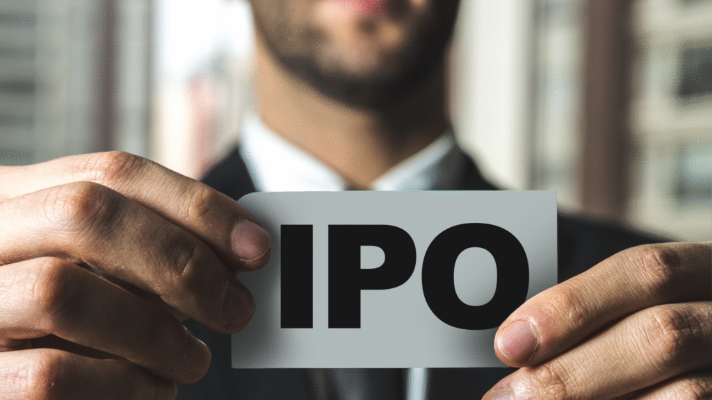 Hands holding IPO sign symbolizing startup valuation and public market entry.