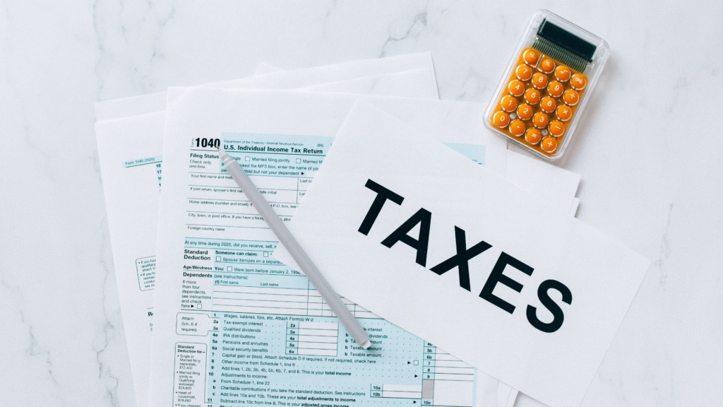 Taxpayer preparing estimated tax payments with forms and calculator