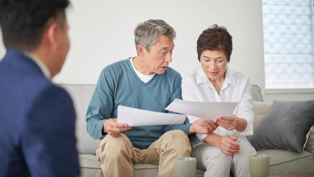 Senior couple reviewing retirement planning documents with financial advisor
