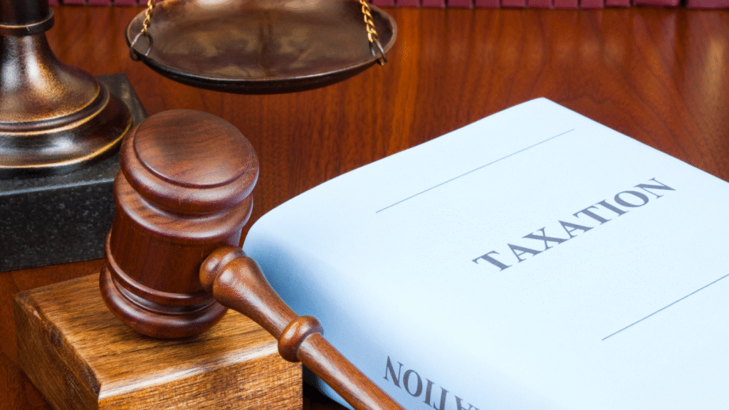 Taxation law book with judge’s gavel and scales of justice