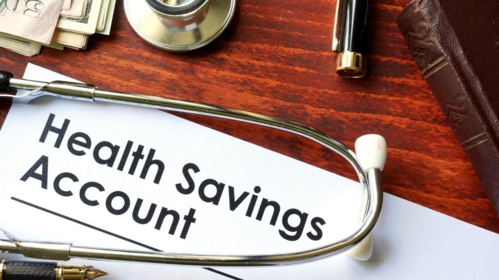 Health Savings Account document with stethoscope on wooden desk.