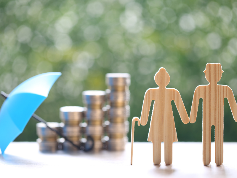 Senior retirement planning concept with umbrella protection and stacked coins