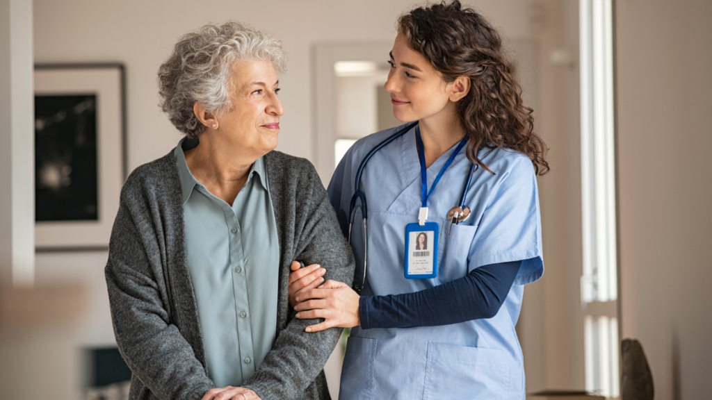 Nurse providing supportive long-term care assistance to an older woman at home